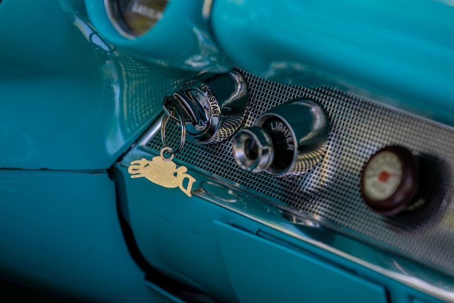 Hand turning a key in a car ignition
