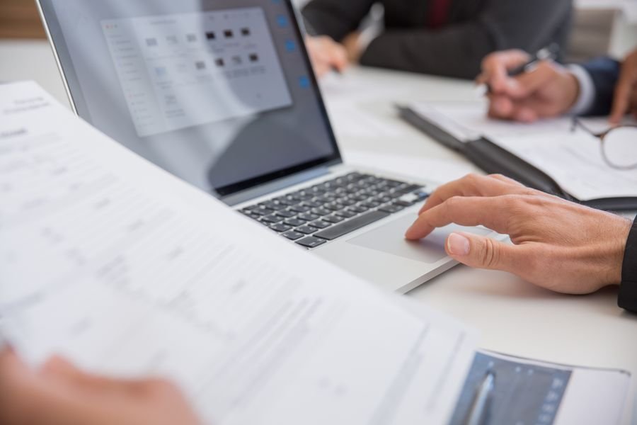 Person reviewing a credit report on a laptop