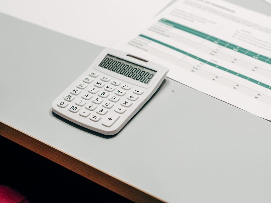 Open ledger with a pen and a calculator